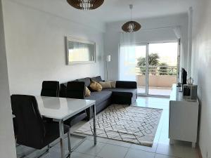 a living room with a couch and a table at Front Beach Apartment - Quinta da Barracuda in Albufeira