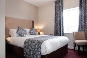 Кровать или кровати в номере Kyle Hotel ‘A Bespoke Hotel’