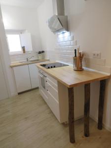 a kitchen with a wooden counter top in a room at Casa da Rita in Évora +8 photos
