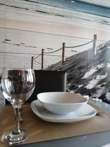 a table with a bowl and a wine glass at INFINITY Blue 2 in Burgas