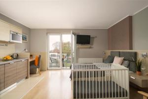 un piccolo soggiorno con divano e cucina di Kaskada Spa & Comfort Willa a Jastrzębia Góra