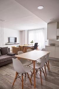 a kitchen and a living room with a table and chairs at Loft Beta in Castellón de la Plana