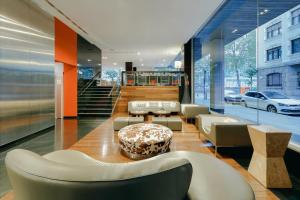 a lobby with chairs and a table in a building at Hesperia Bilbao in Bilbao