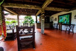 a room with tables and chairs in a building at Linaje Salvaje Hotel in Calarcá