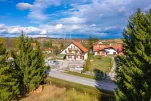 a house in a suburb with a road and trees at Guest house Padine Zlatibora in Zlatibor