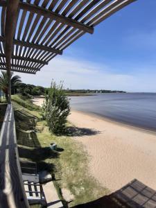 a view of the beach from a beach house at Eugenio Araus Apartamento 504 in Colonia del Sacramento