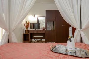 a bottle of champagne on a tray on a bed at Aeolis Boutique Hotel in Naxos Chora