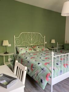 a bedroom with a bed and two tables with lamps at B&B La Grancia in Chiaravalle
