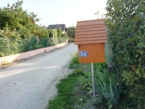 a mailbox on the side of a road at Chambre dans Maison Campagnarde in Présilly
