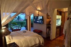 a bedroom with a bed with a television in it at Jakita's Guest house in Ballito