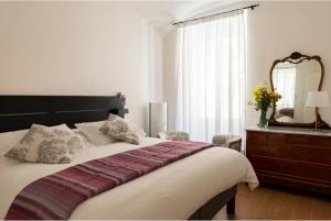 a bedroom with a bed with a mirror and a dresser at A casa di Rosanna in Rome