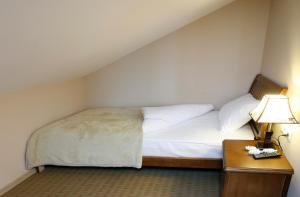 A bed or beds in a room at Abu Hotel