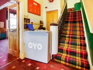 an omo kiosk in a hallway next to a staircase at OYO Glenpark Hotel, Ayr Central in Ayr