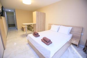 a bedroom with a bed with two towels on it at Apartments KiM Sandanski in Sandanski
