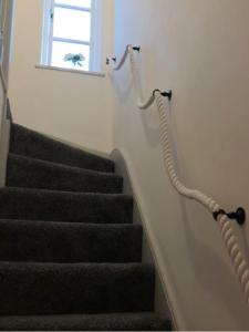 a stairway with a stair case and a window at Fisherman’s Cottage in Y Felinheli