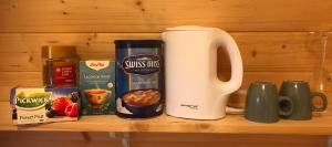 a wooden shelf with a coffee maker and some food at Ásahraun Guesthouse in Selfoss