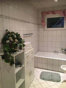 a bathroom with a tub and a toilet and a sink at Ferienwohnung Nett in Adenau +34 photos