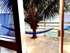 a beach scene with a beach umbrella and a boat at The Sea Cliff Hotel Resort & Spa in Port Antonio
