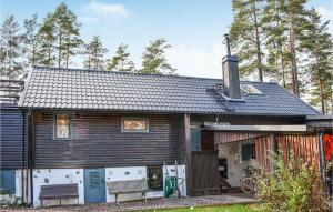 una casa de madera con un banco delante en Gorgeous Home In Tidaholm With Kitchen en Tidaholm