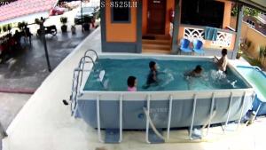 a group of people in a swimming pool at Maena Water Chalets in Tumpat