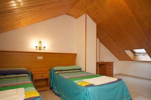Postel nebo postele na pokoji v ubytování Hostal Vinuesa