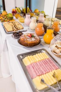 un buffet de comida en una mesa blanca en Estocolmo Hotel by bund en Mar del Plata