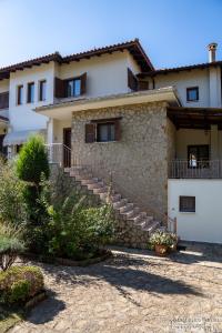 una casa con escaleras y una pared de piedra en Villa Luxury Paradise Kastoria, en Lithiá