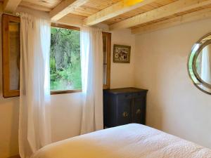 a bedroom with a bed and a window at Anex les Corominotes in Olot