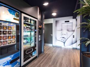a drink station with a soda vending machine at Ibis budget Rouen Petit Quevilly in Le Petit-Quevilly