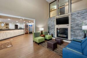 a lobby with a living room with a fireplace at Comfort Inn South in Indianapolis