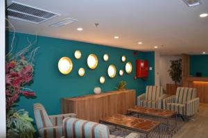 a waiting room with chairs and a wall with mirrors at Boutique Urban Madrid Génova in Madrid