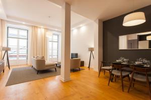 a living room with a dining room table and chairs at FLH Luxus Baixa Flat in Lisbon