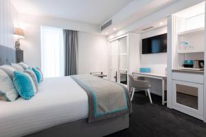 a hotel room with a large bed and a desk at Hotel Juliani - Boutique Hotel in St. Julianʼs