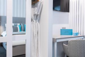a room with a bed and a desk and a chair at Hotel Juliani - Boutique Hotel in St. Julianʼs
