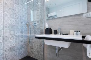 a bathroom with a sink and a shower at Hotel Juliani - Boutique Hotel in St. Julianʼs