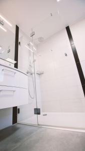 a bathroom with a shower with white walls at Landgasthof Scherer in Wenden