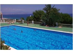 a large blue swimming pool with people in it at Bungalow Mediterraneo in Santa Pola +38 photos