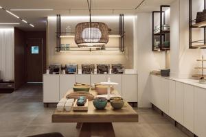 a kitchen with a table with bowls on it at Hotel Juliani - Boutique Hotel in St. Julianʼs