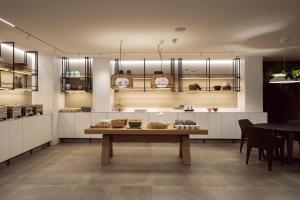 a kitchen with a table with bowls on it at Hotel Juliani - Boutique Hotel in St. Julianʼs