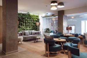 a lobby with a couch and tables and chairs at Hotel Juliani - Boutique Hotel in St. Julianʼs