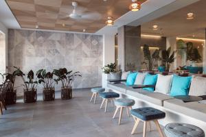 a lobby with blue and white furniture and plants at Hotel Juliani - Boutique Hotel in St. Julianʼs