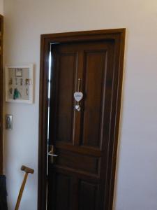 a wooden door in the corner of a room at LES CHAMBRES DU GAVE D'OSSAU in Arudy