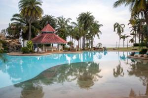 a swimming pool with a gazebo and palm trees at F5 3 Bed Rooms Beach house, full kitchen in Rayong