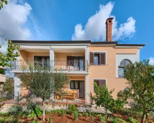 an exterior view of a house with a chimney at Apartments Vera Savic in Poreč