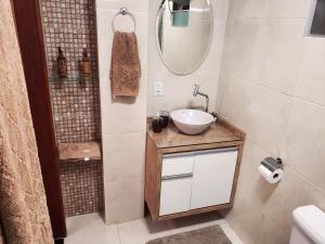 a bathroom with a sink and a mirror at Plumeria Guest House in Florianópolis +16 photos