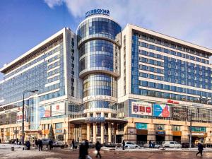 a large building with people walking in front of it at Adagio Moscow Kievskaya in Moscow