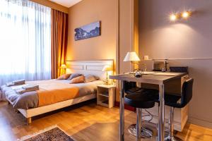 a bedroom with a bed and a desk in it at La Villa in Rouen