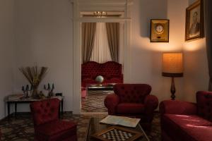 a living room with red chairs and a red couch at Villa Giordanelli in Scalea