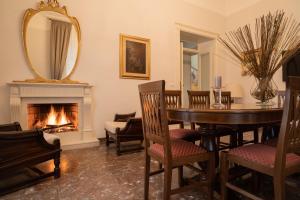 a dining room with a table and a fireplace at Villa Giordanelli in Scalea