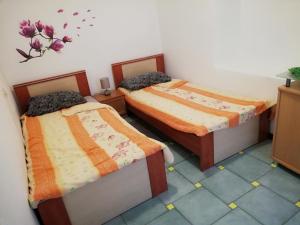 a room with two beds in a room at Apartment Anita 1 in Rijeka
